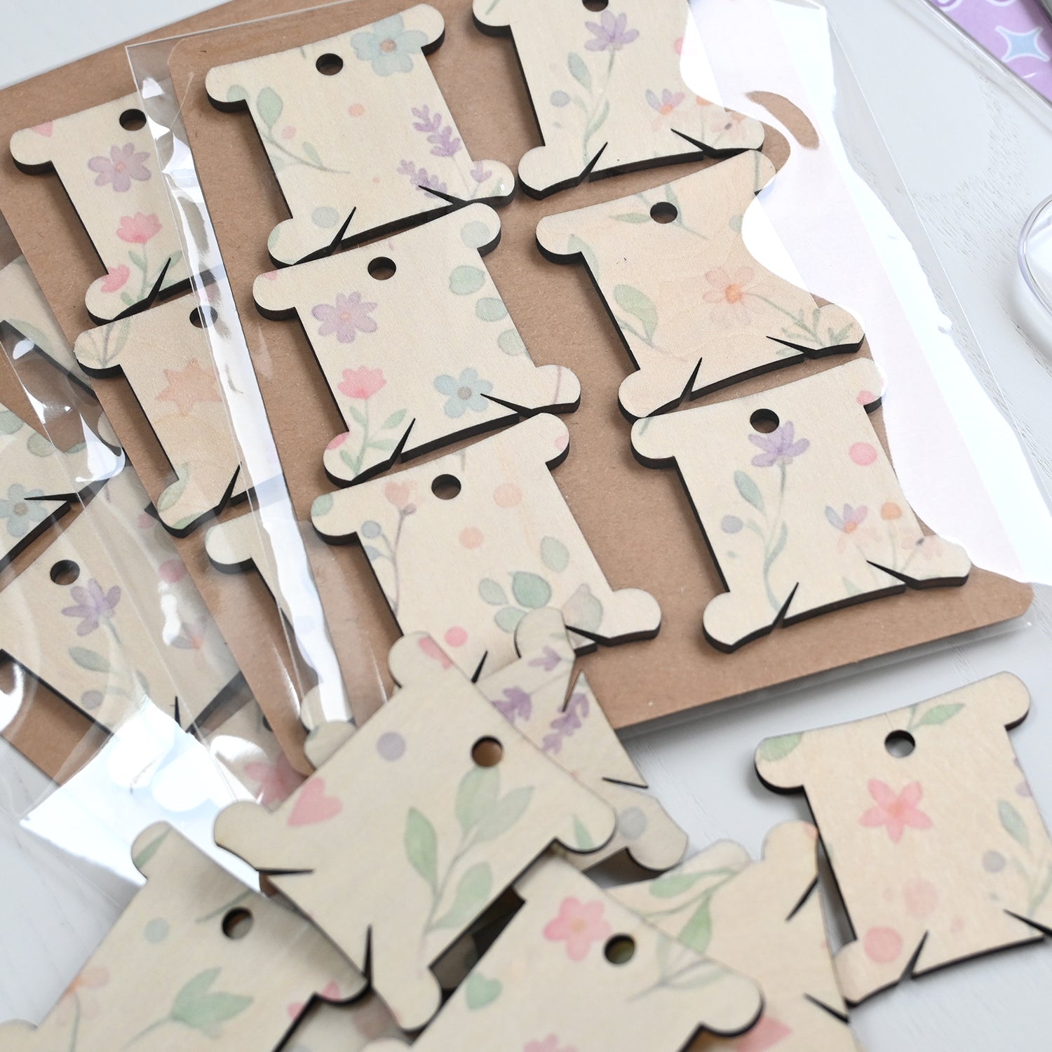 Packs of plywood embroidery or cross stitch thread bobbins.