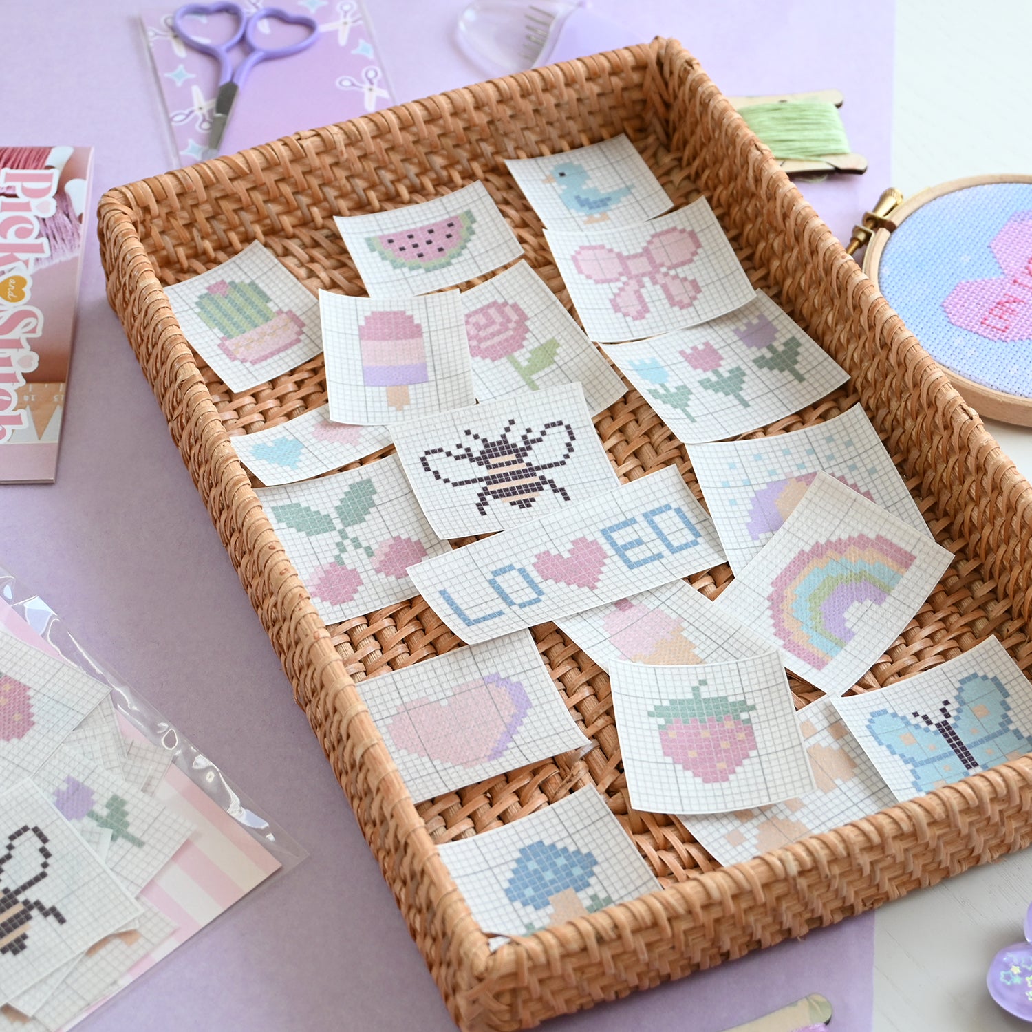 Wicker tray with small cross-stitching patches on a light purple surface.